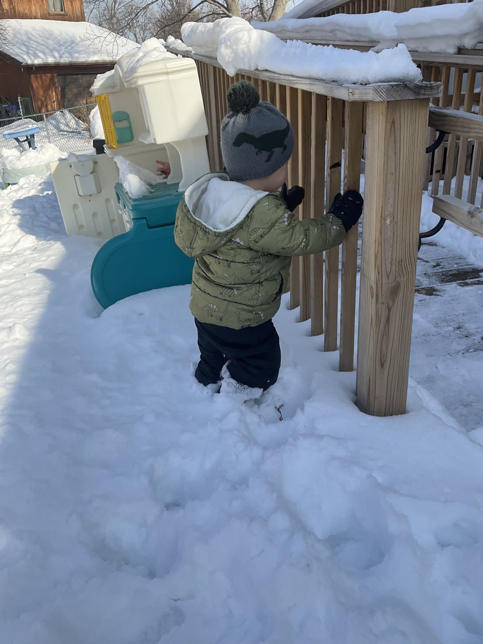 Toddler exploring snowy playground at Little Acorns Erie PA