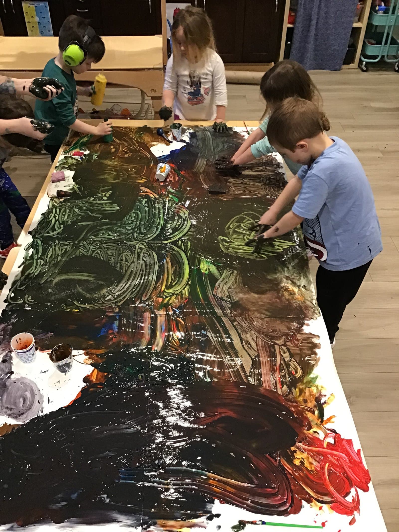 Great Oaks preschool kids painting a giant collaborative canvas