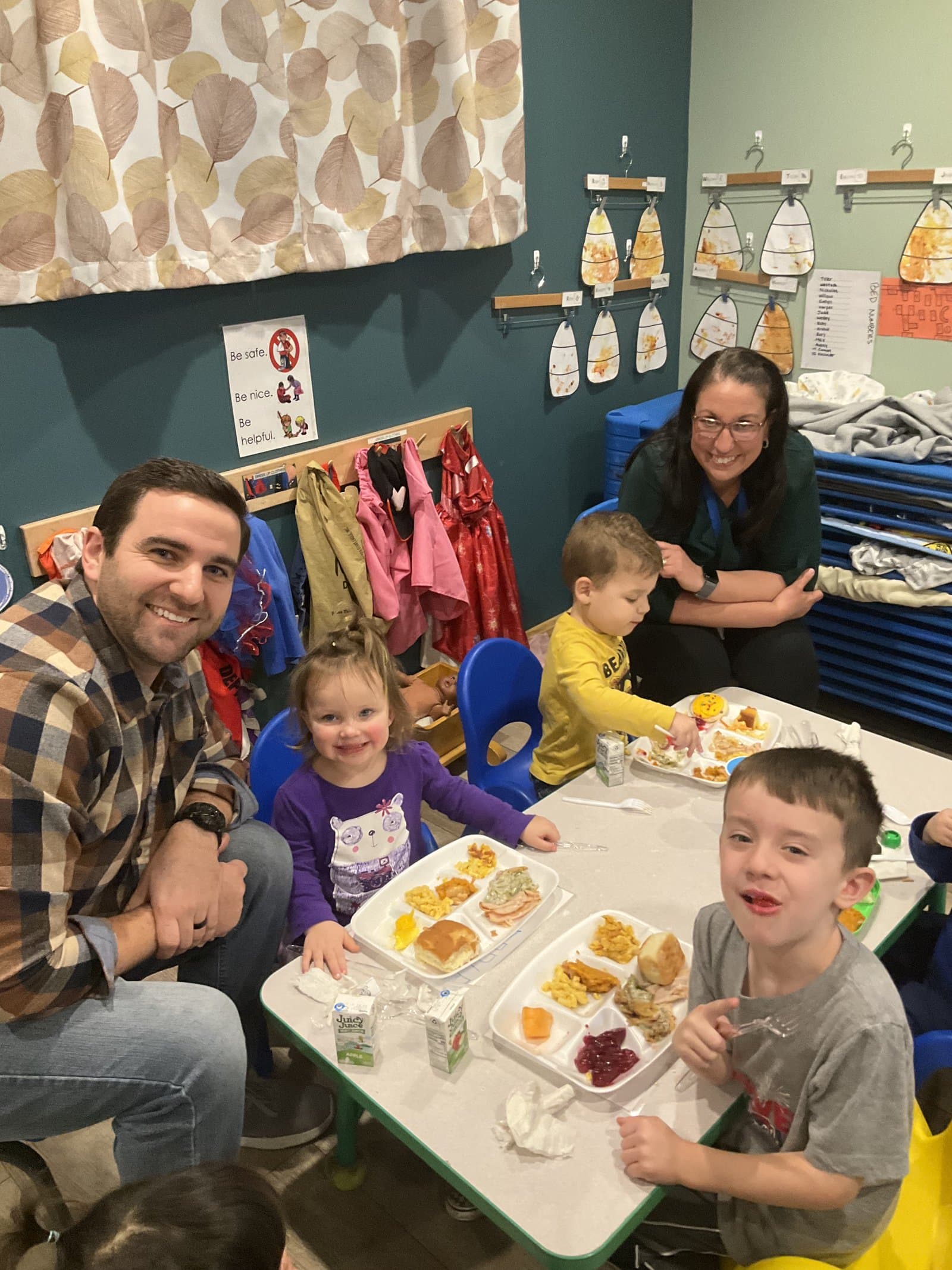 Family lunch in the Little Acorns classroom — parents and children eating together
