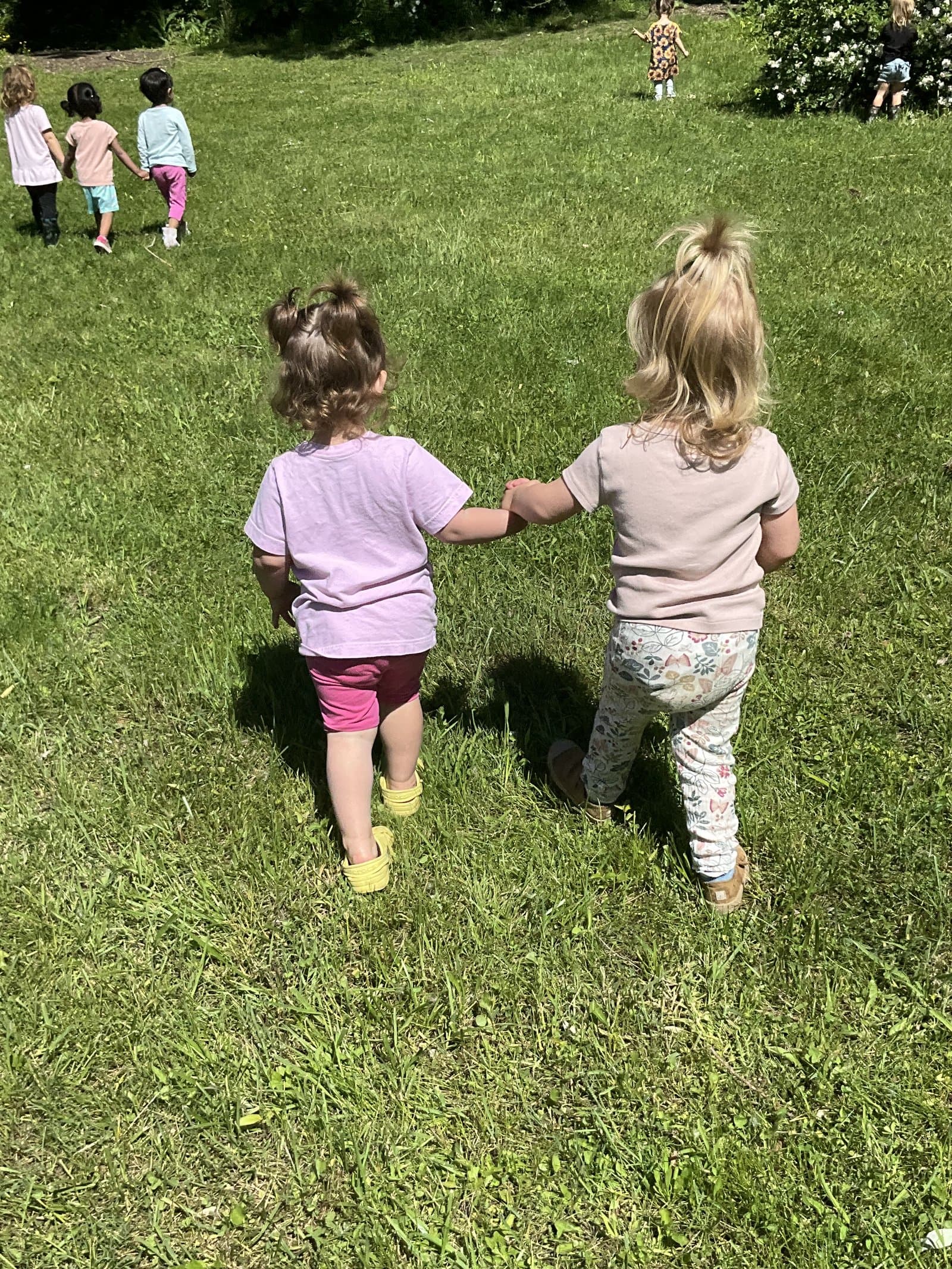 Two Little Acorns Saplings holding hands on the playground